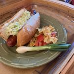 Grilled Brat with topping called "Everything"