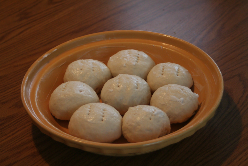 Unbaked inner rolls in round baking dish.